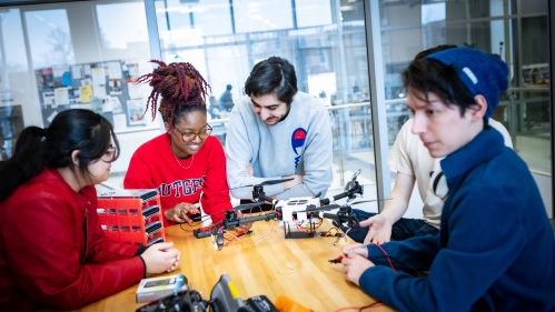 Four students work on a project in an engineering lab.