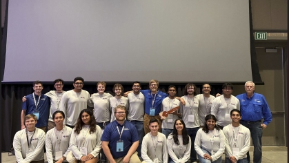 2 rows students front row is kneeling and back row is standing
