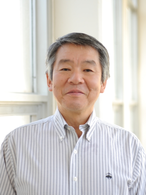 Head shot of Asian male wearing a white patterned button down shirt.