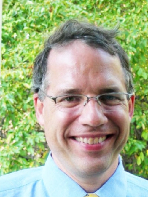 Head shot of male with short hair and eyeglasses.