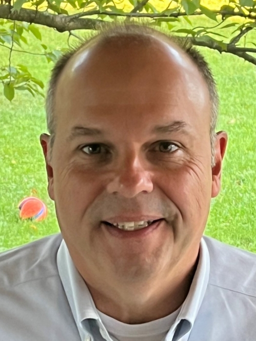 man in front of tree branch and green grass